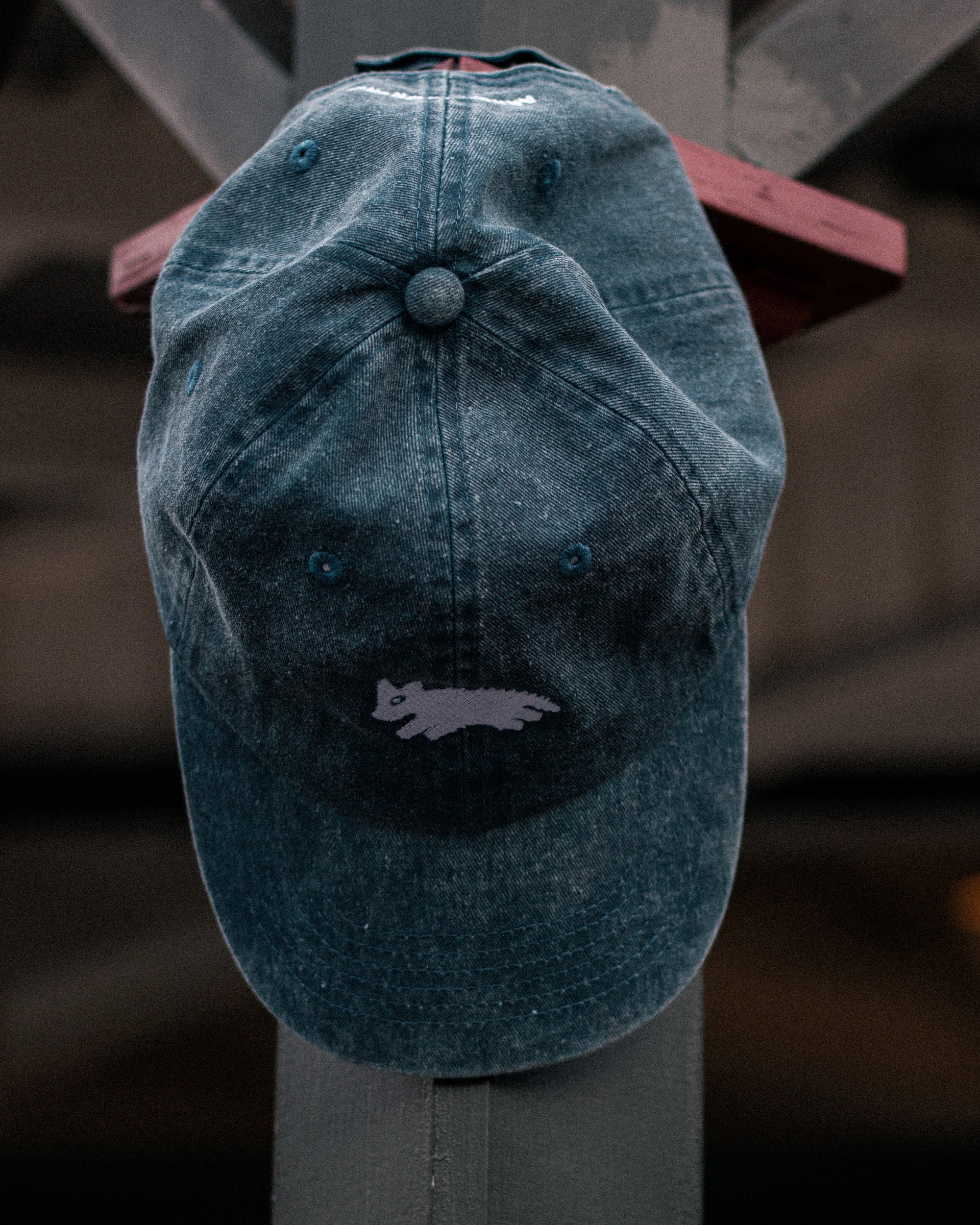 Blue denim cap with a logo.